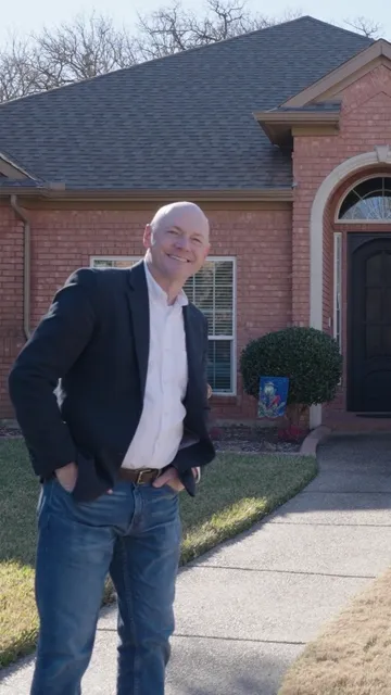 Homeowner in front of a finished home